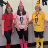 The youth services librarians dressed up as crayons. From left to right, Rabecca as red, Sara as pink, and Barb as yellow.