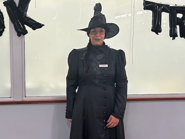 Library assistant Bernice, dressed up in a witch costume.