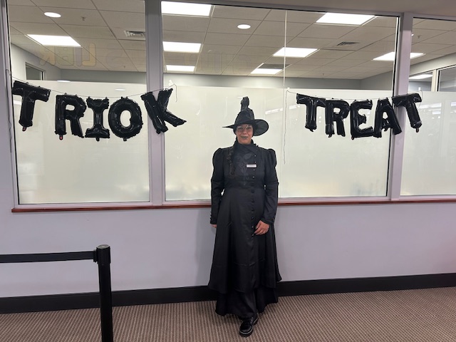 Library assistant Bernice, dressed up in a witch costume.