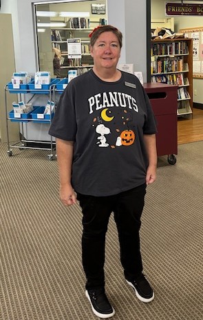 Library Director Sheila, in a Peanuts Halloween t-shirt featuring Snoopy