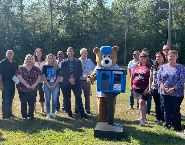 Heggan and Bells staff stand behind the new Little Free Library