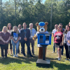 Heggan and Bells staff stand behind the new Little Free Library